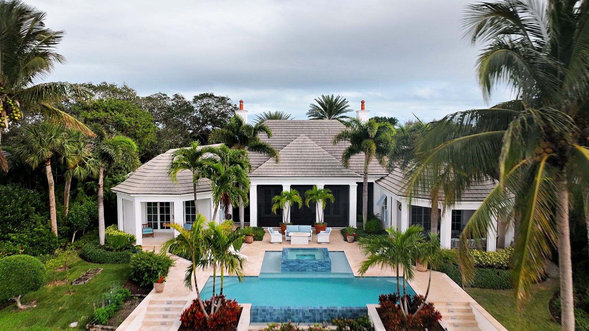 Aerial of a luxury Florida property with pool and palms.